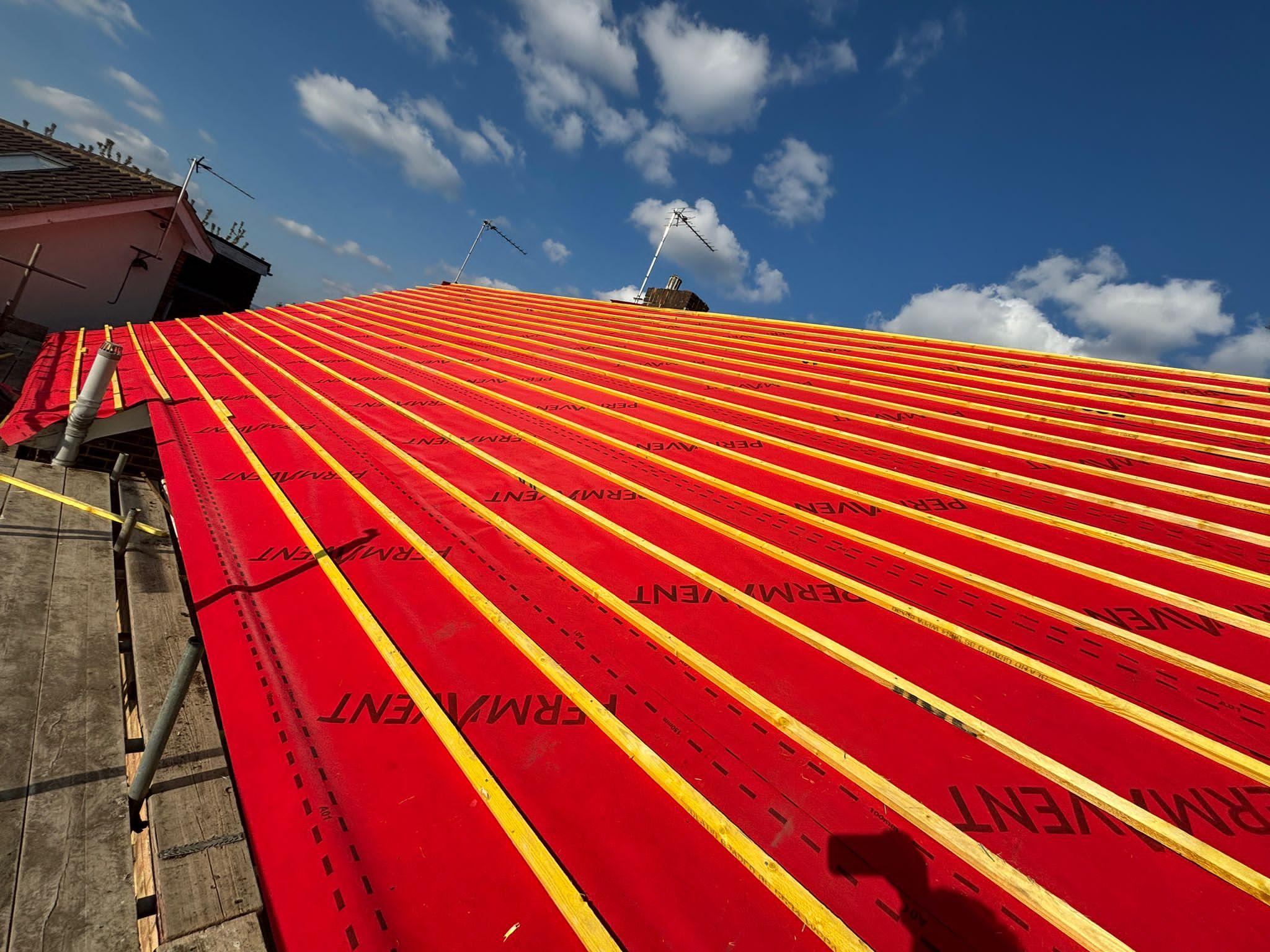 Completed re-roofing project with fresh tiling and clean ridge detail