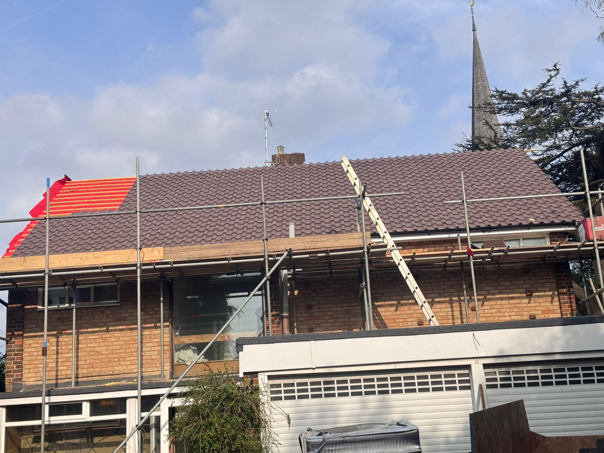 Re-roofing in progress showing new tiled roof covering by ATS Roofing